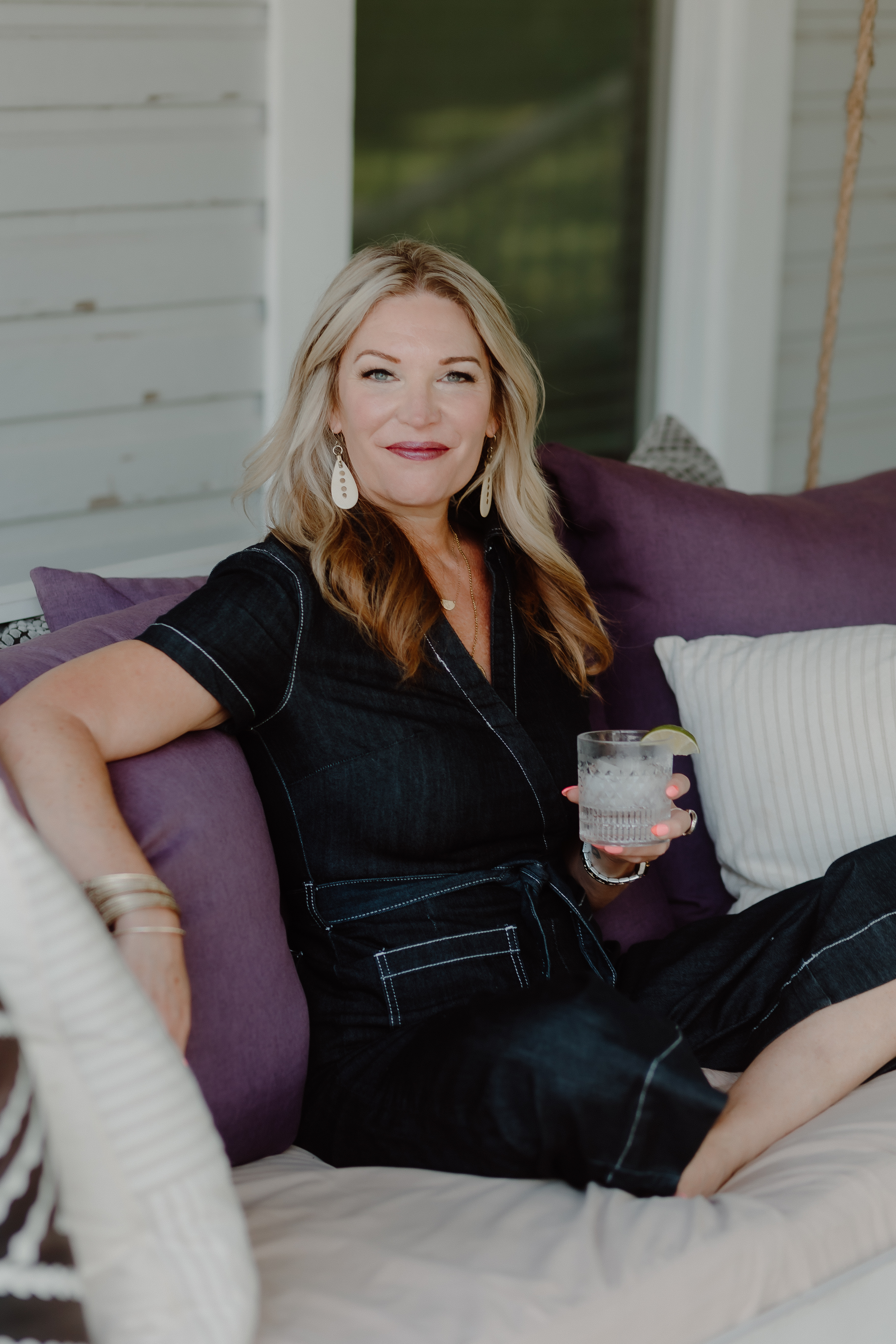 image of female author Jen Hatmaker seated on her sofa with a coffe mug in her hands