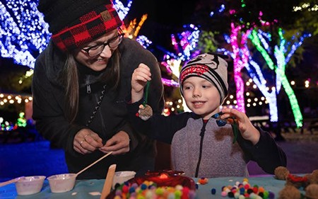 Child participating in Dallas Zoo night event.