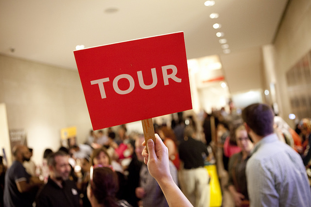 Tour sign held in the air.