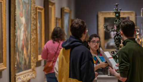 A docent answers questions in gallery