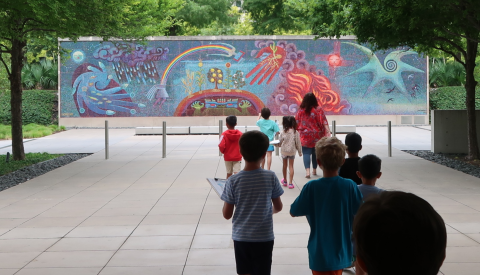 A school tour visits the mosaic